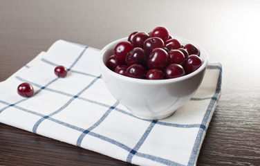 Bowl of сherries on a table.Copy space