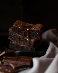 Pile of brownie poured over with topping