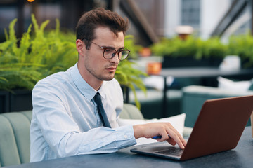 businessman working on his laptop in park