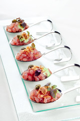 Top view catering banquet table with cold snacks. Raw tuna Tartare decorated capers, close up. Dishes in the restaurant. easy food for guests. Party food.
