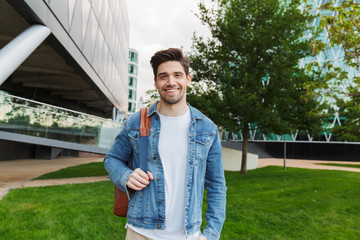 Handsome young man dressed casually spending time outdoors