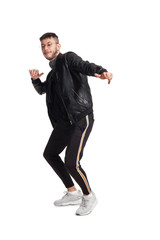 Full-length photo of a funny guy dancing in studio isolated on white background.