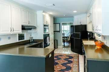 Small kitchen with white cabinets and a tiled floor