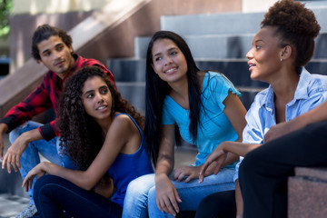 Group of young latin american and hispanic immigrants in city