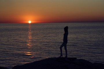 silhouette of woman at sunset