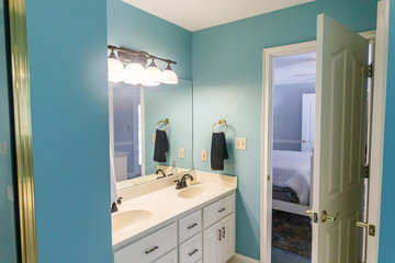 Bright blue colorful spacious master bathroom.