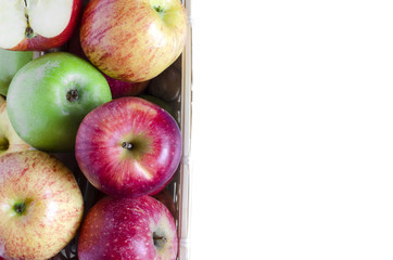 apples red and green in a wicker basket white background isolate