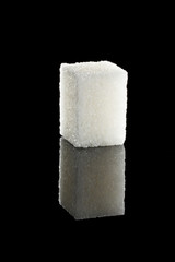 sugar cubes on a black mirror background