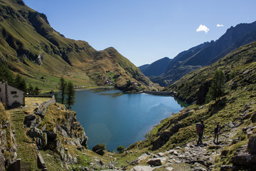 Mountain lake with two tourist, trekking