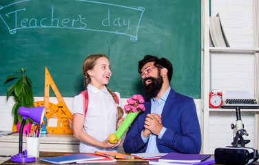 flower present for best teacher. teachers day. Daugghter and father with flowers. back to school....
