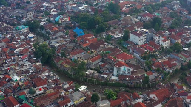 BANDUNG, Indonesia - July 03, 2019: Aerial view of crowded residential houses in Bandung city, West Java, Indonesia. Shot in 4k resolution from a drone flying forwards
