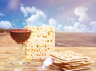 passover background. wine and matzoh (jewish passover bread)  over wooden background. vintage...