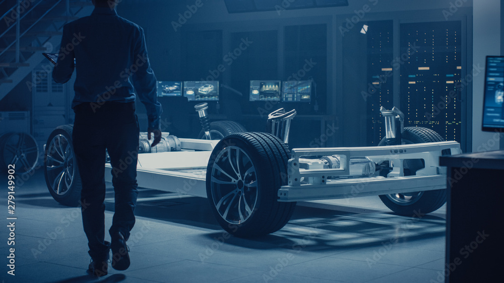 Leinwandbilder automobile engineer enter automotive innovation facility to work on electric car chassis platform, u