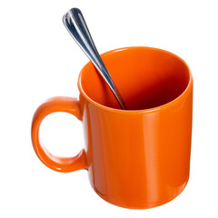 Orange coffe tea cup mug with tea spoon on white background isolation