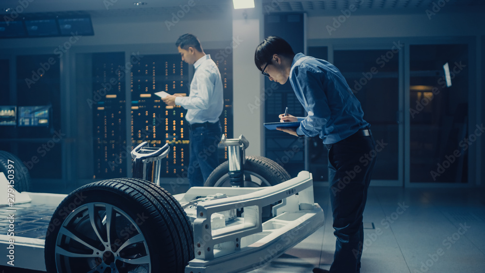 Poster automotive engineers working on electric car chassis platform, taking measures, working with 3d cad 