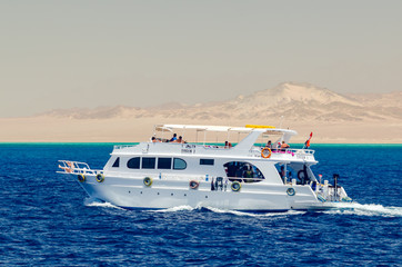 Sharm El Sheikh, Egypt May 08, 2019: Pleasure tourist boat with passengers sailing in the clear blue water of the Red Sea.