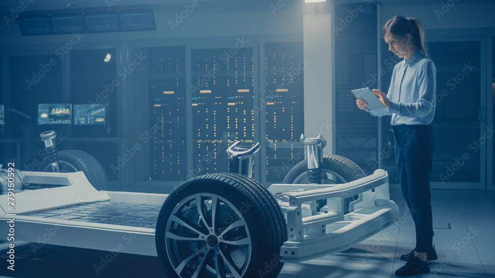 Aufkleber Automobile Engineer Working on Electric Car Chassis Platform, Using Tablet Computer Augmented Reality with 3D CAD Software Modelling. Innovative Facility: Vehicle Frame with Wheels, Engine, Battery