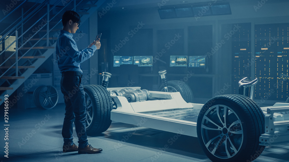 Aufkleber Automobile Engineer Working on Electric Car Chassis Platform, Using Tablet Computer Augmented Reality with 3D CAD Software Modelling. Innovative Facility: Vehicle Frame with Wheels, Engine, Battery