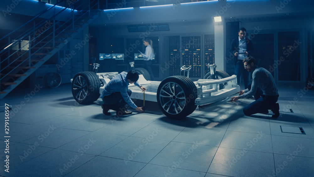 Leinwandbilder automobile engineer working on electric car chassis platform, using tablet computer augmented realit