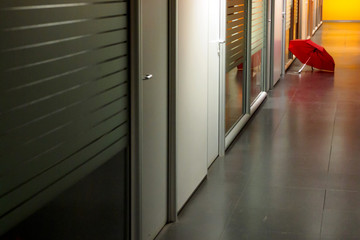 Umbrella open in office corridor