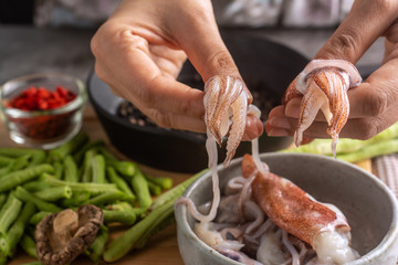 Housewives Hands and squid Cooking ConCept.