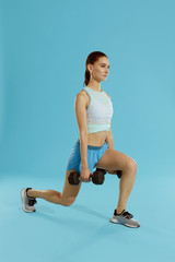 Fitness workout. Woman exercising with gym weight at studio