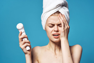 young woman applying cream on her face