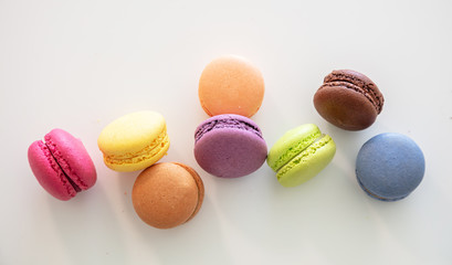 Fototapeta na wymiar Colorful macarons on white background, close up view