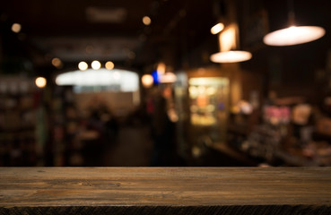 Beer barrel with beer glasses on a wooden table. The dark brown background.