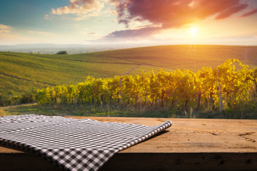 Obraz na płótnie Canvas Vineyard tabletop design. Wine background. Autumn design with vineyard and empty display. Autumn grapes harvest