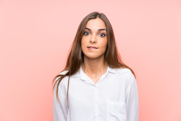 Fototapeta premium Young woman over isolated pink background having doubts and with confuse face expression