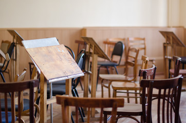 Empty art class audience with worn chairs and easels, artist's studio