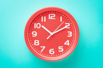 Top view closeup red alarm clock on green background