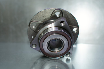 Car wheel hub on a steel background. Close-up. Automobile spare parts.