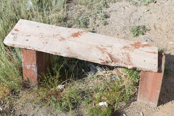 old, homemade, wooden bench in the street