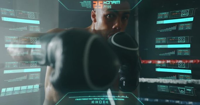 Slow motion shot of a professional young muscular shirtless african man is wearing futuristic vr glasses with latest innovative technology augmented reality holograms to practice shadow boxing.