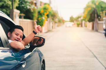 car with man hands up lifestyle driving freedom on street in city blurred background.For automotive automobile or transport transportation image.