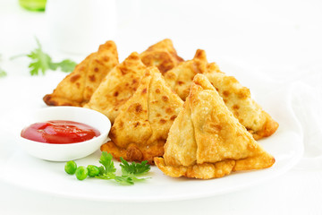Asian food. Vegetarian samsa (samosas) with tomato sauce