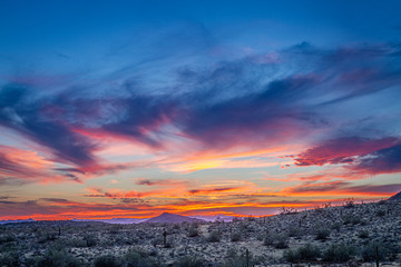 A sunset over the Sonoran Desert of Arizona with high altitude clouds.