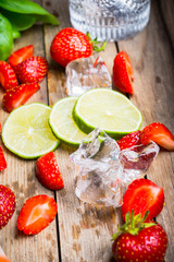 Ingredients for cocktail with strawberry and basil leaves. Selective focus. Shallow depth of field.