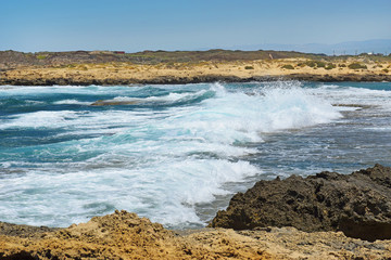 sea wave crashing on rocks