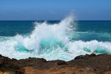 sea wave crashing on rocks