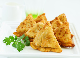 Asian food. Vegetarian samsa (samosas) with tomato sauce