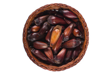 Isolated Brazilian Pinion fruit in a wood basket  with one open seen from above