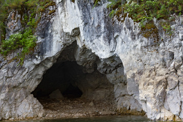The rocky shore of the Krasnoyarsk reservoir. The Krasnoyarsk Sea. Rocky coast with trees. Cave..