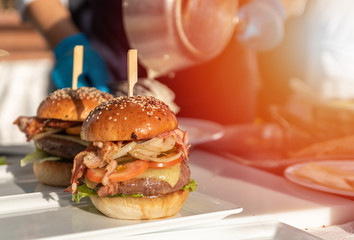Homemade beef hamburger gaurmet food with chef cooking in background