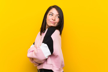 Fototapeta na wymiar Young Mexican woman over isolated yellow background laughing