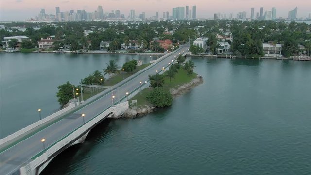 Aerial: The Venetian Islands in Biscayne Bay at sunrise. In the background is downtown Miami. Florida, USA.