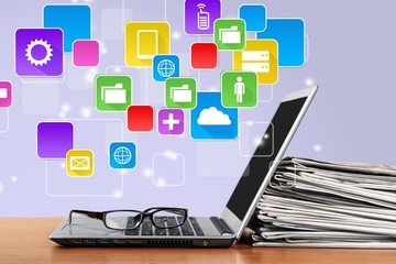 Laptop and black glasses  on   background.