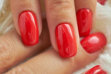 perfect red manicure. nail and hand care in the salon.